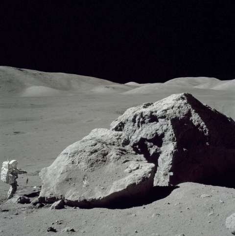 Scientist-Astronaut Harrison H. Schmitt is photographed standing next to a huge, split boulder during the third Apollo 17 extravehicular activity (EVA-3) at the Taurus-Littrow landing site on the Moon. Schmitt is the Apollo 17 lunar module pilot. This picture was taken by Astronaut Eugene A. Cernan, commander.